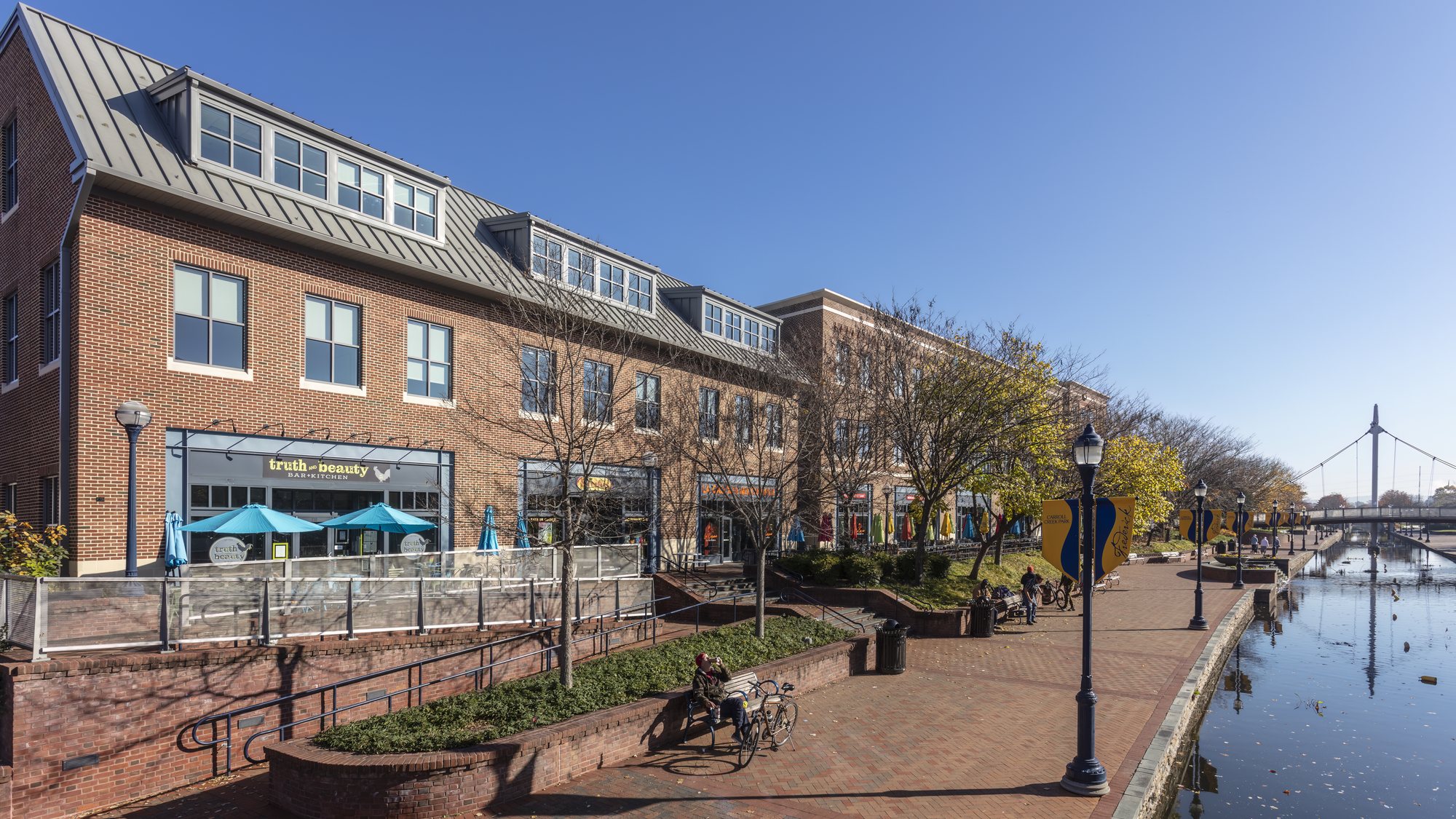 Carroll Creek Park in downtown Frederick, with brick buildings along the water