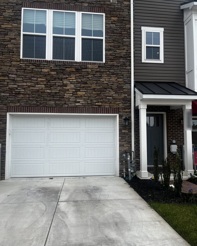 A new townhome in Millersville with a stone front and a garage