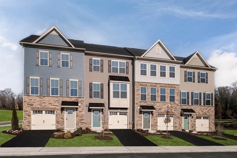A row of new townhomes with stone fronts and garages